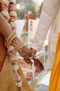 A couple holding hands while standing next to each other