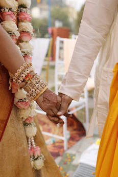 A couple holding hands while standing next to each other
