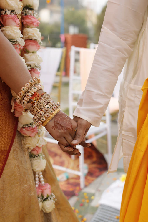 A couple holding hands while standing next to each other