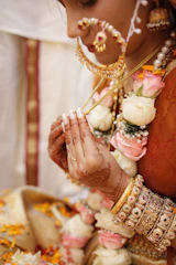 A woman in a bridal outfit holding her hands together