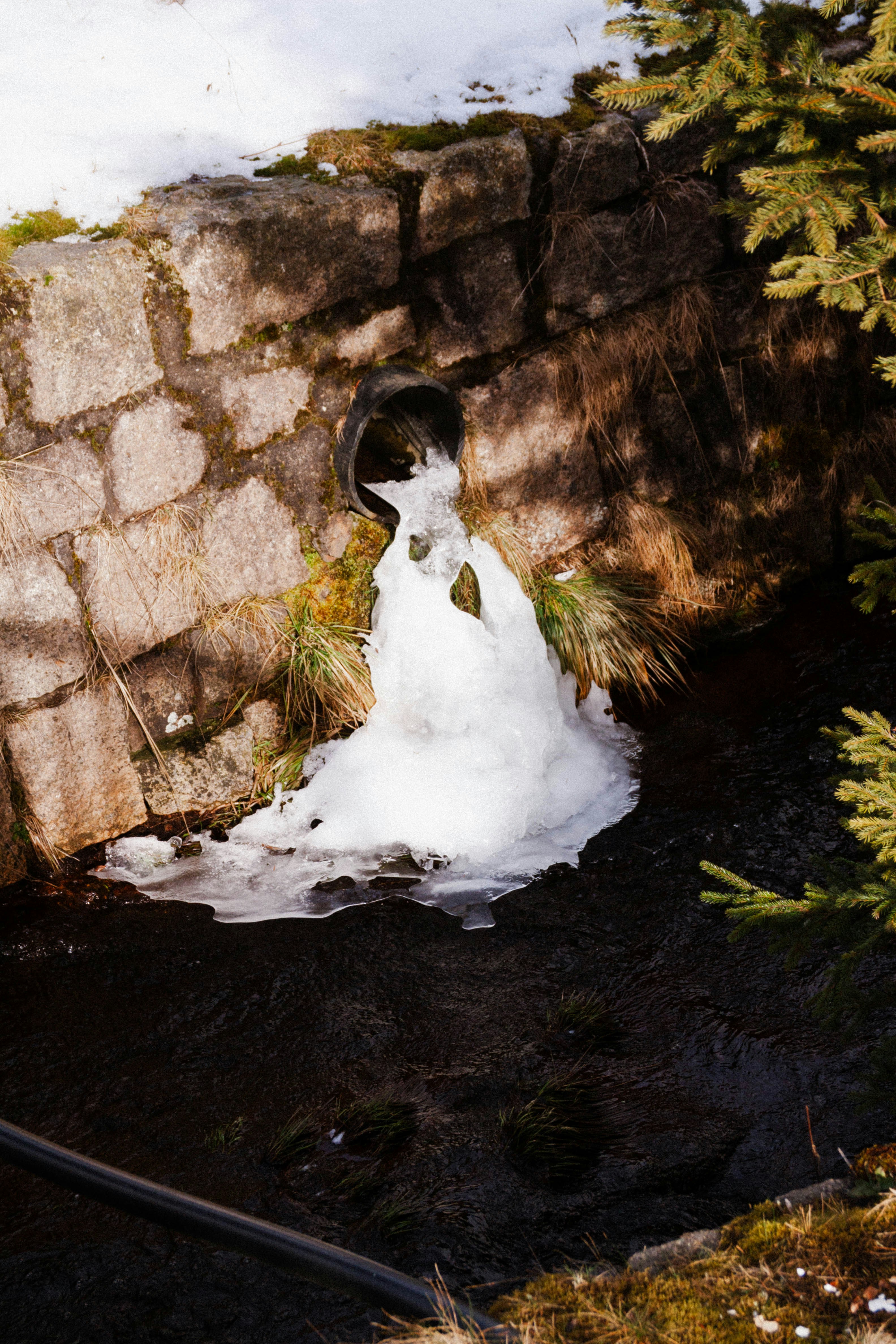 A stream of water running through a stone wall