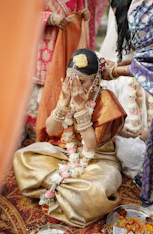 A woman sitting on the ground in front of other women