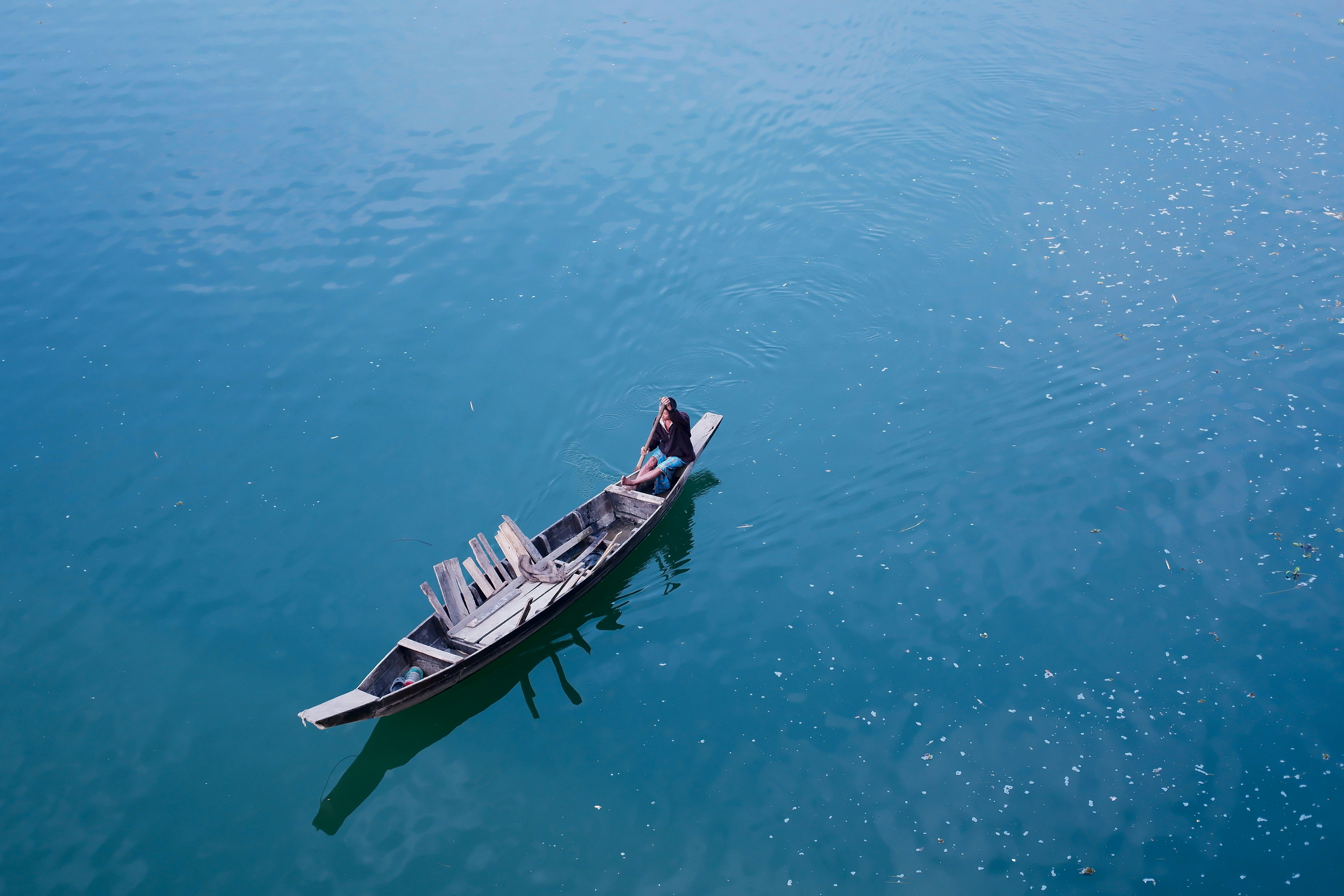 A boat floating on top of a large body of water