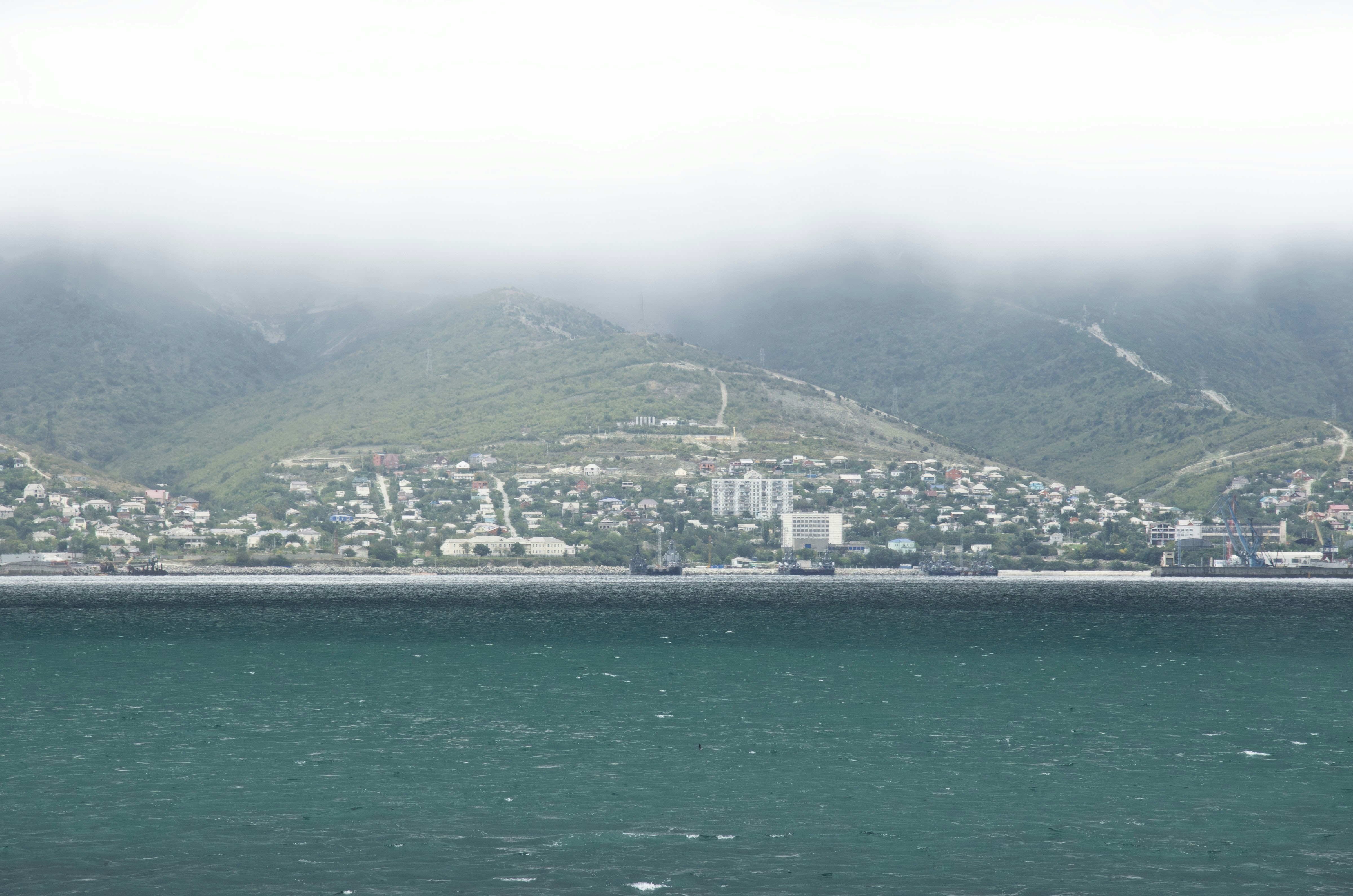 A view of a body of water with a city in the background