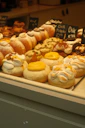 A display case filled with lots of different types of donuts