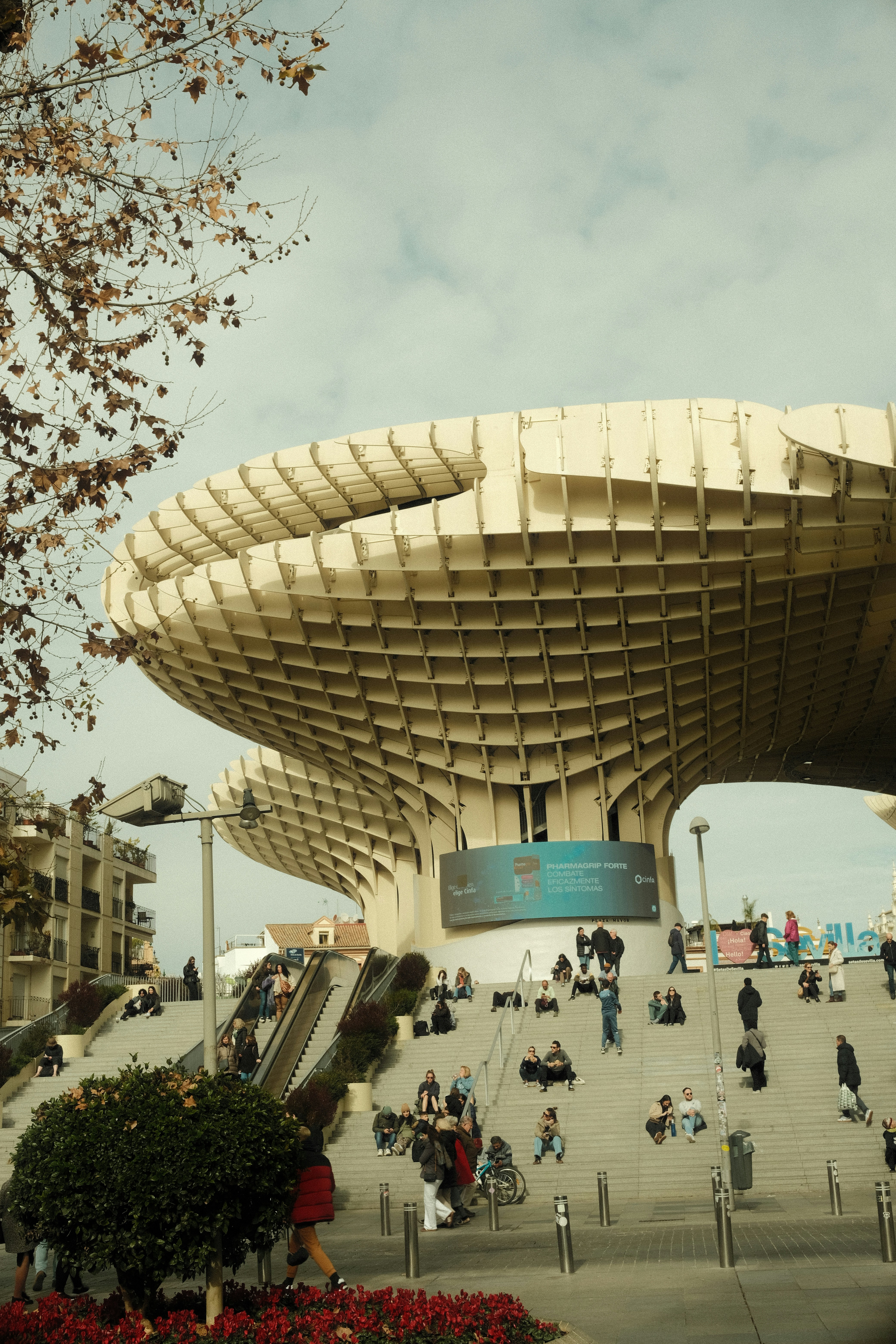 A group of people walking around in front of a building