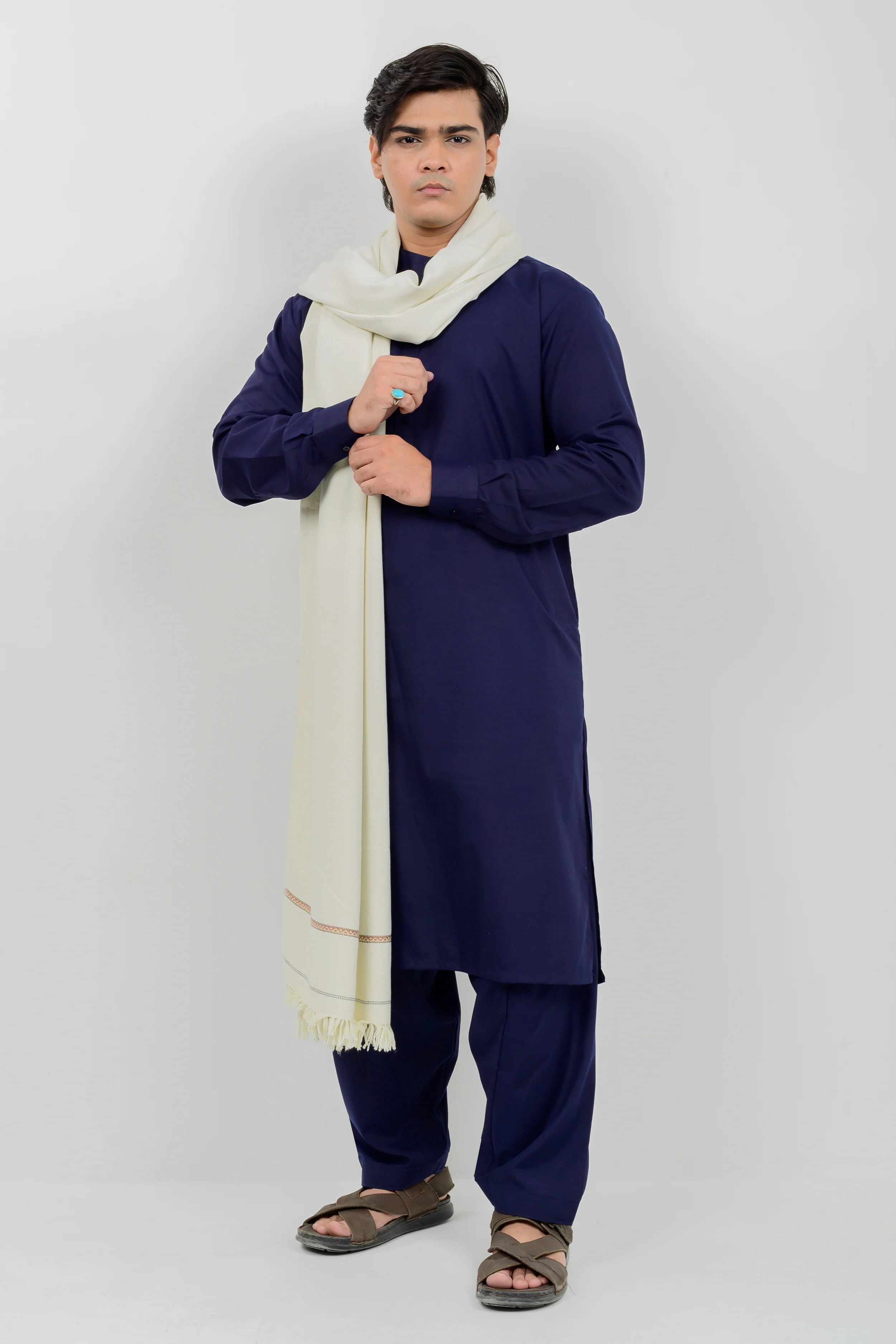 A man wearing a blue outfit and a white scarf