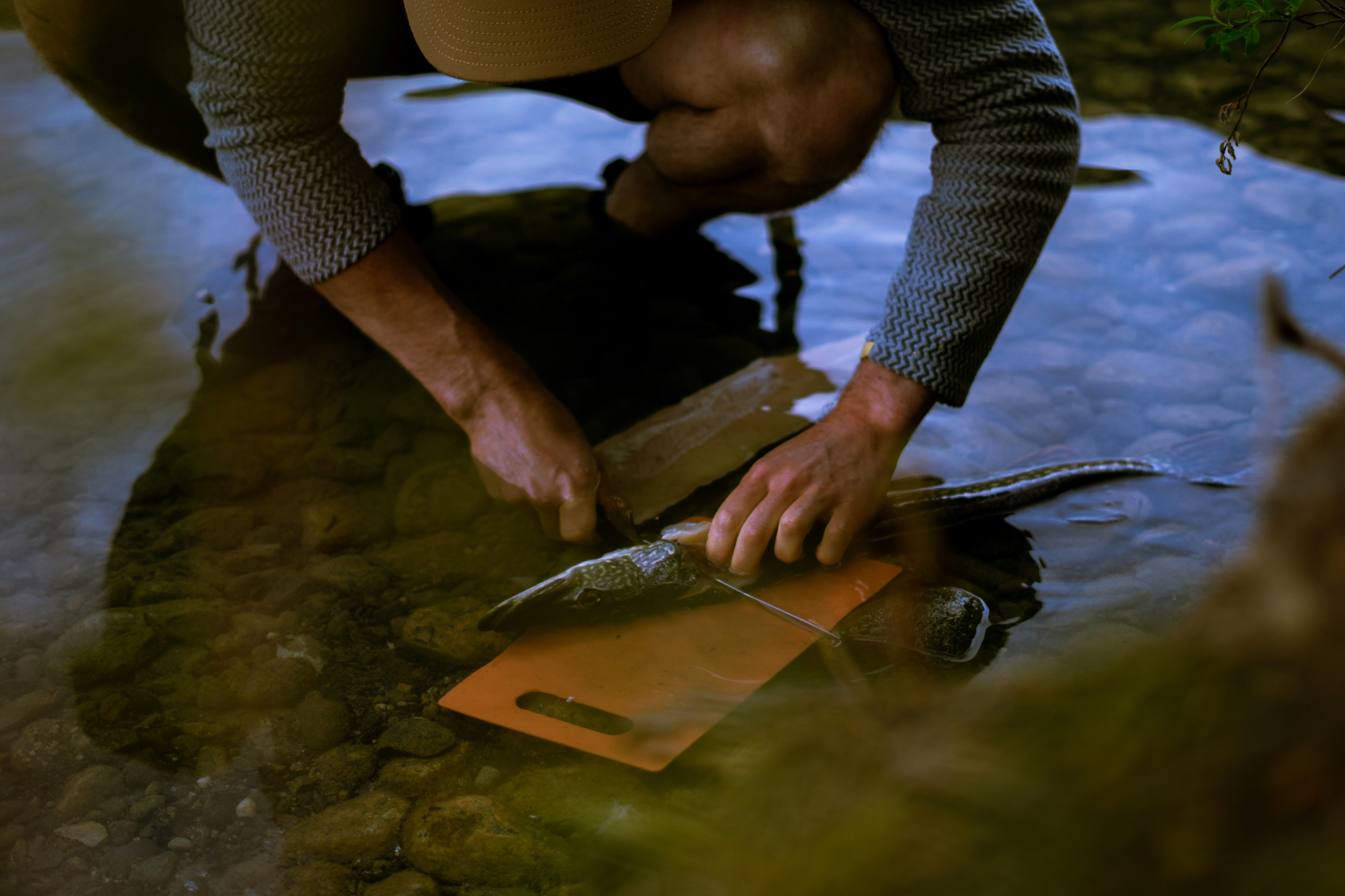 A person demonstrating proper sanding techniques on a wooden surface