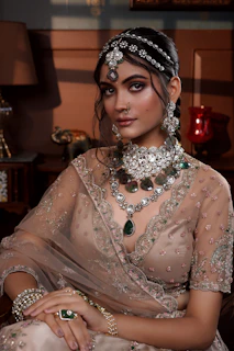 A woman in a bridal outfit sitting on a couch
