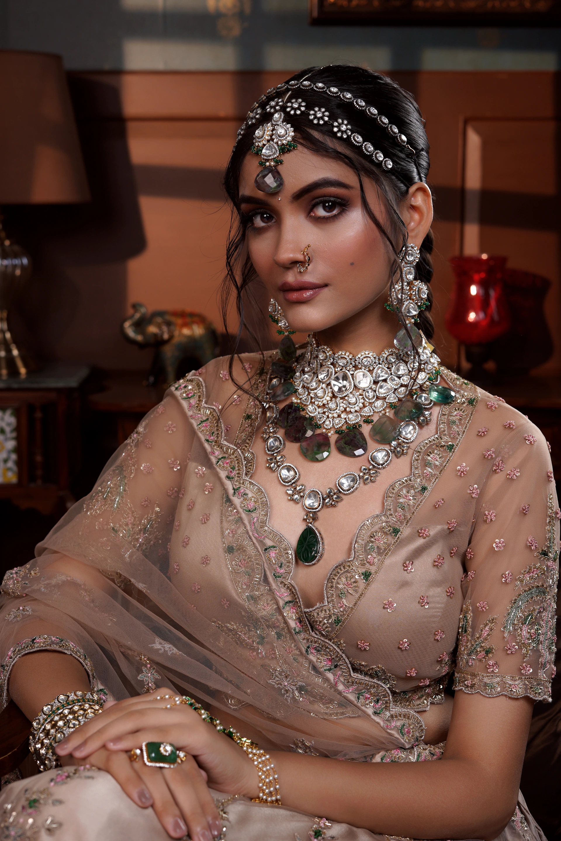 A woman in a bridal outfit sitting on a couch