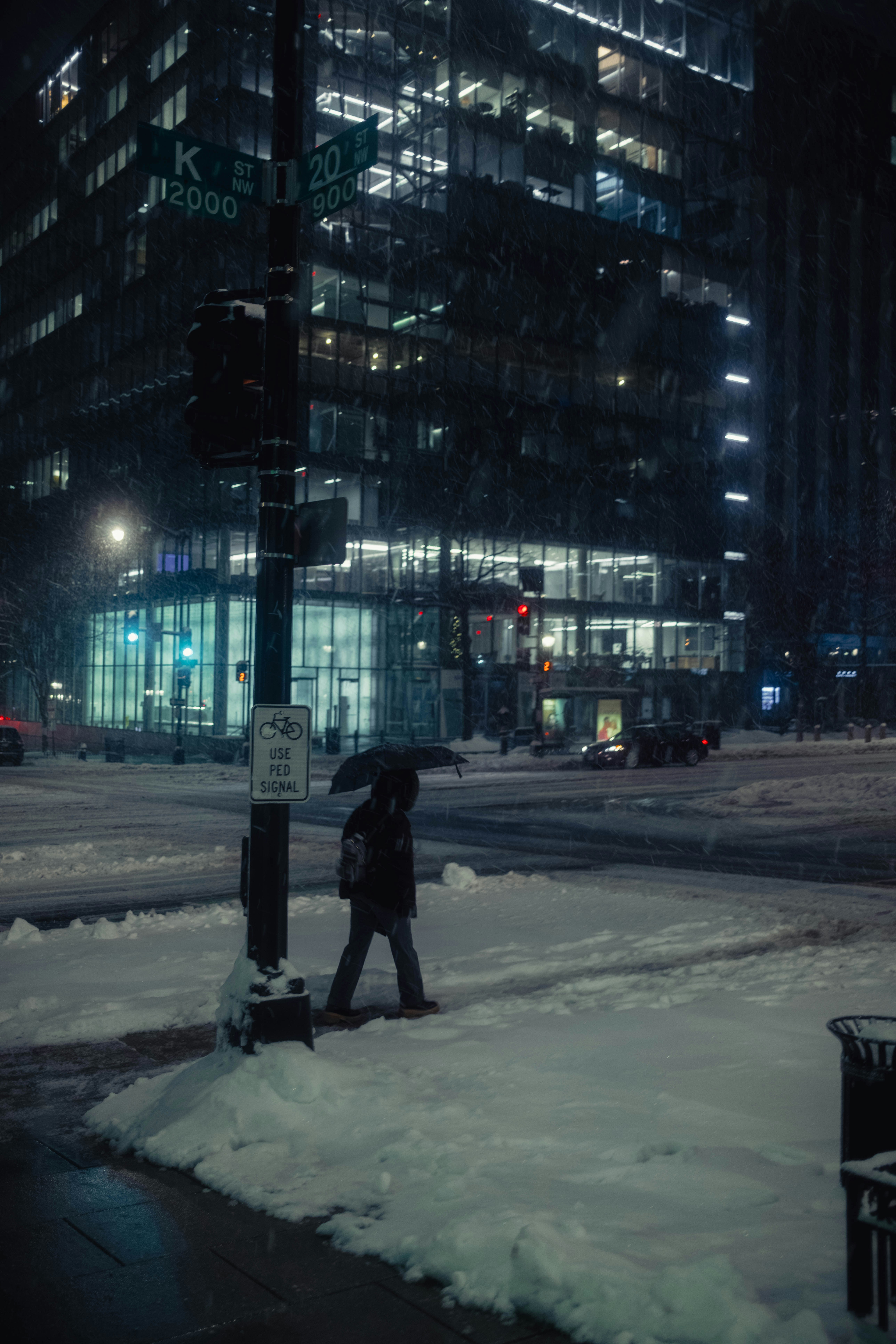 A person walking in the snow with an umbrella