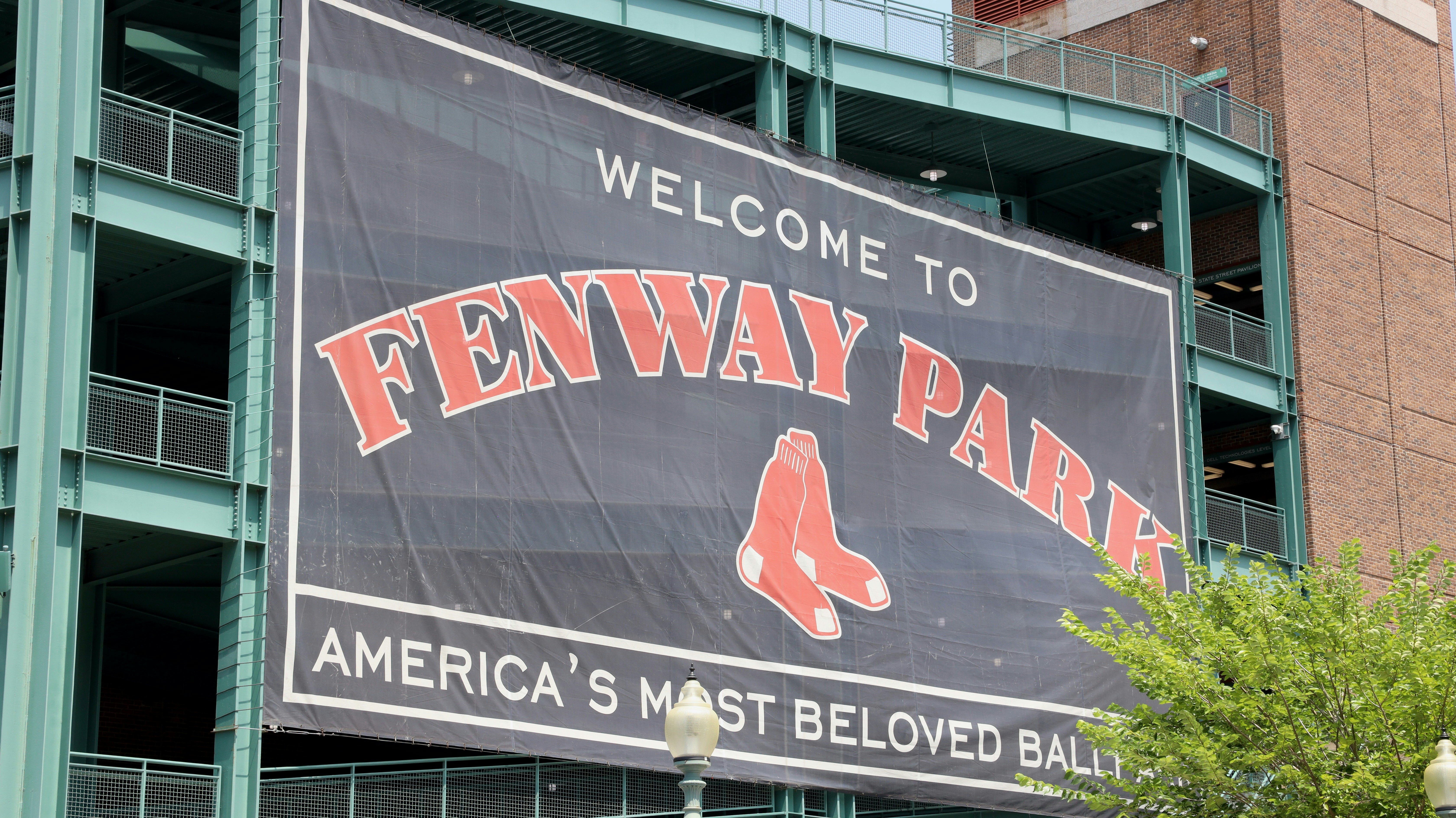 A large sign on the side of a building that says fenway park
