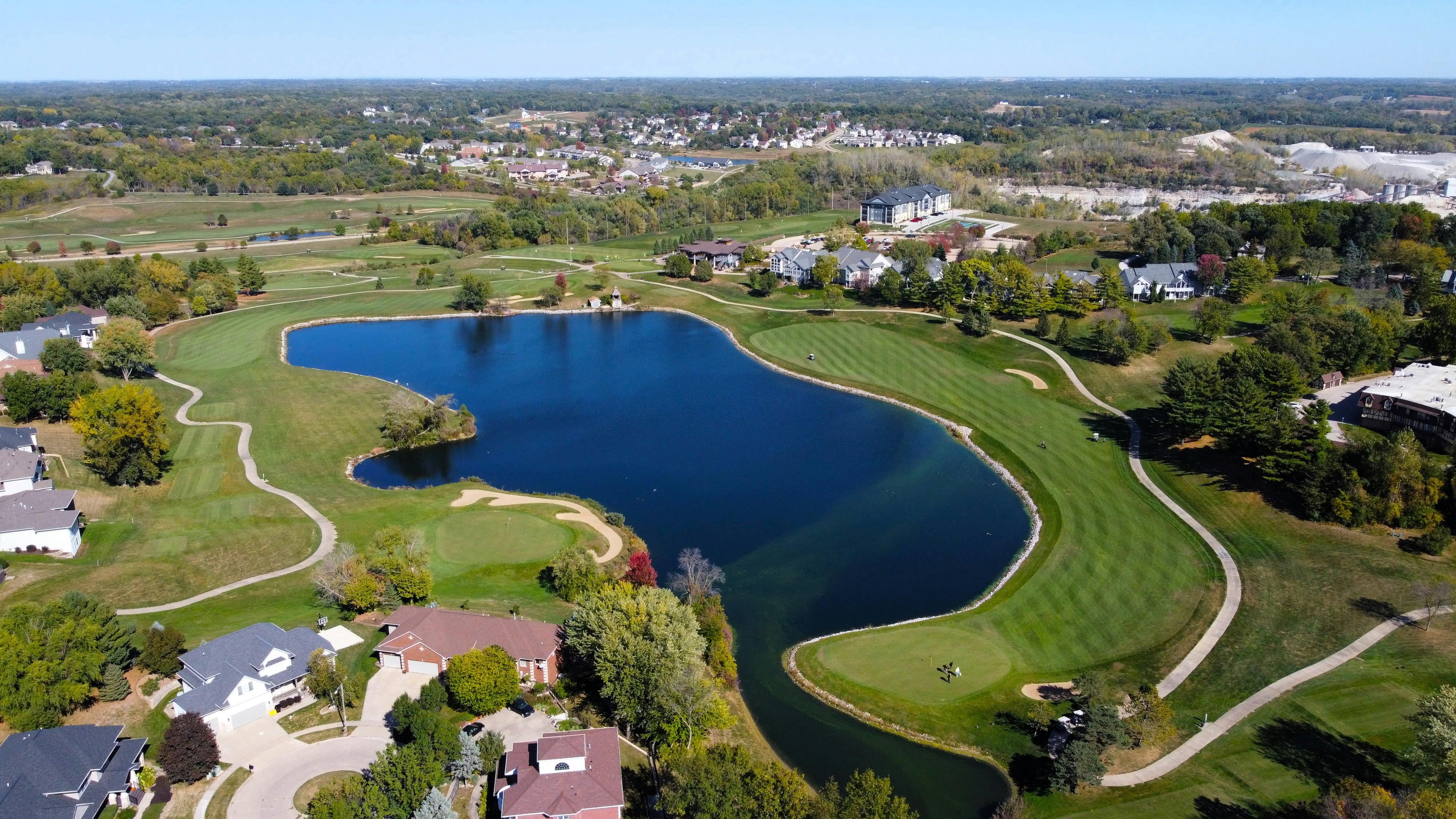 An aerial view of a golf course and a lake