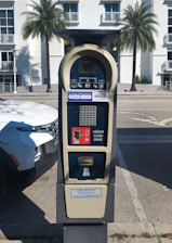 A parking meter sitting on the side of a road