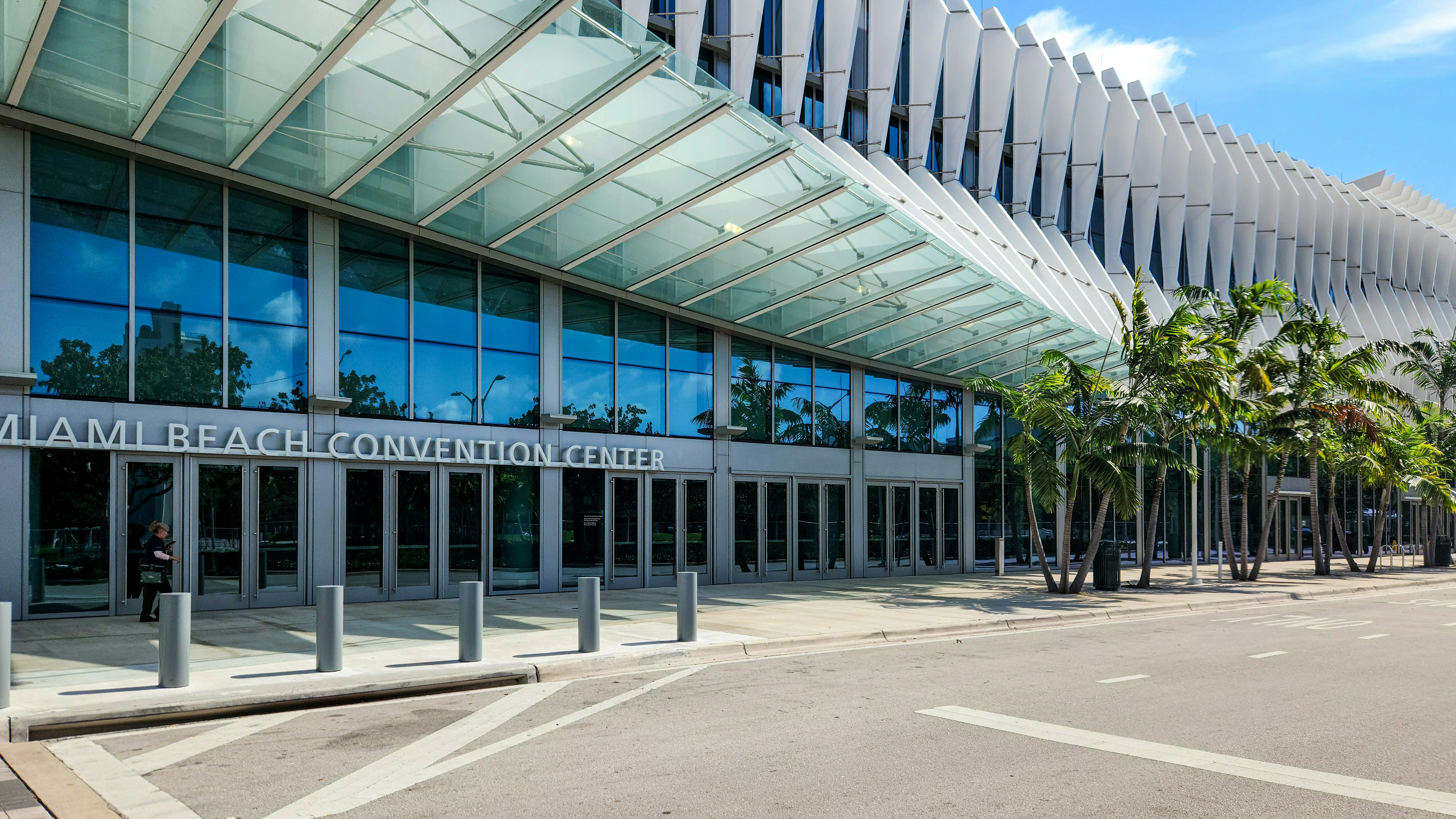 A large building with a lot of windows next to a street