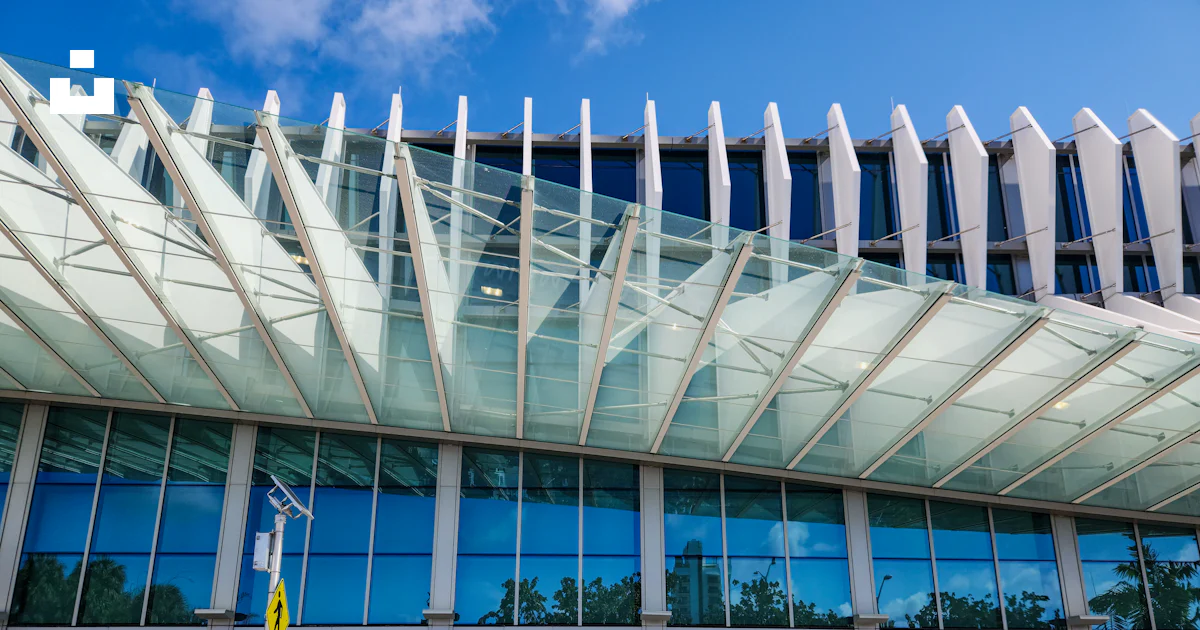 A large building with a large glass front photo – Free City Image on ...