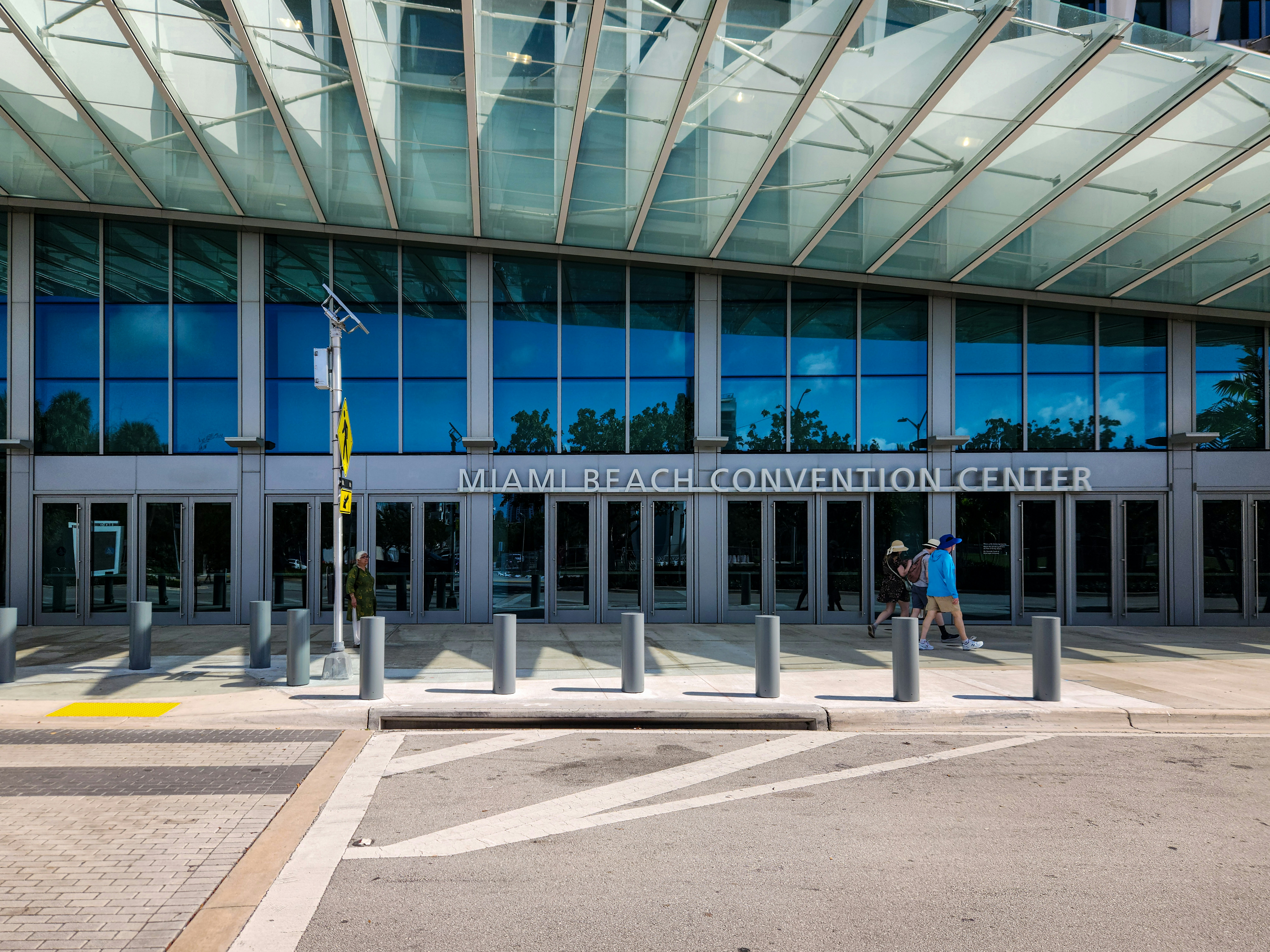 A person walking in front of a large building