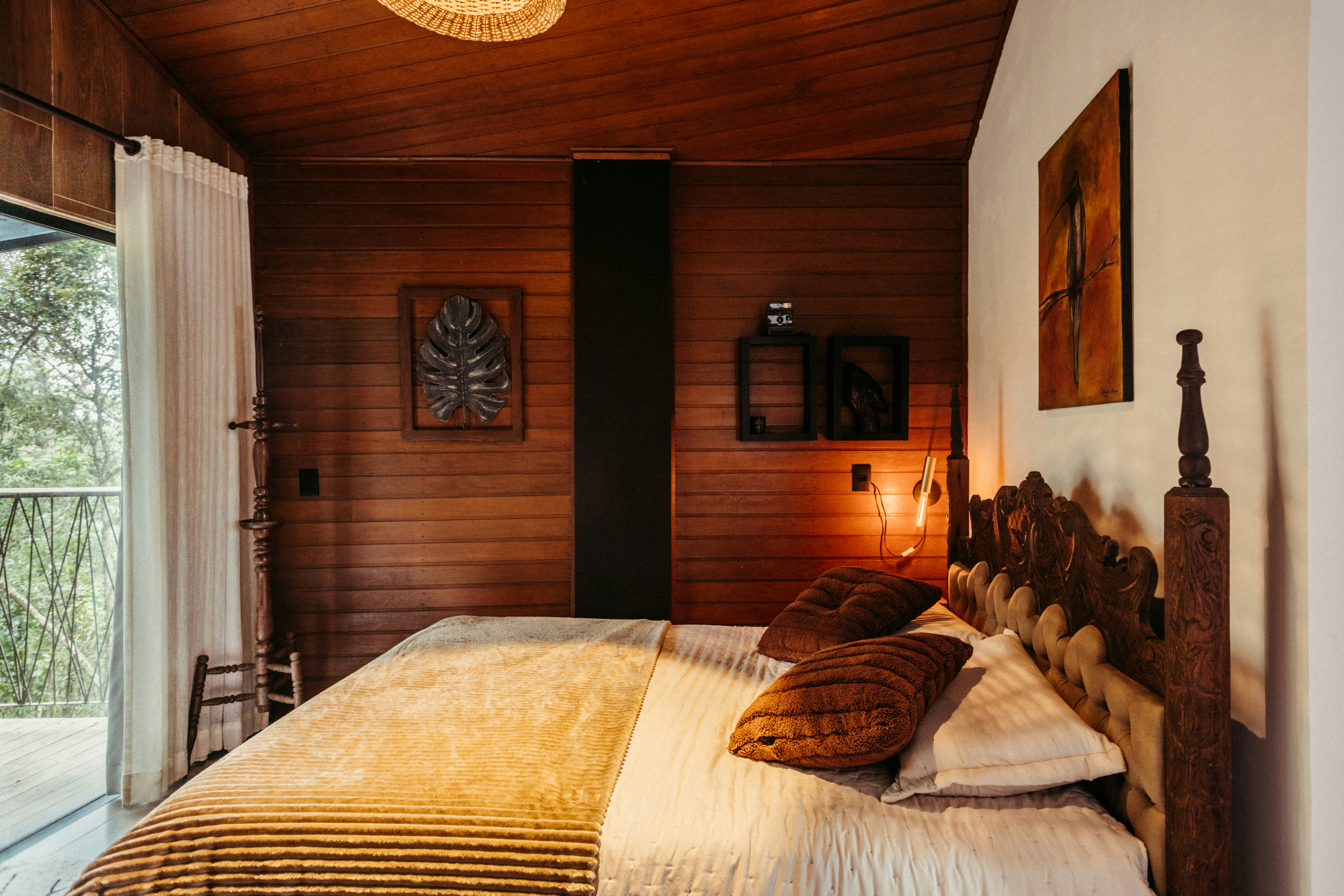 Bedroom with large bed and wooden walls