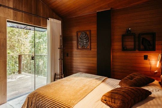 A bedroom with a bed and a sliding glass door