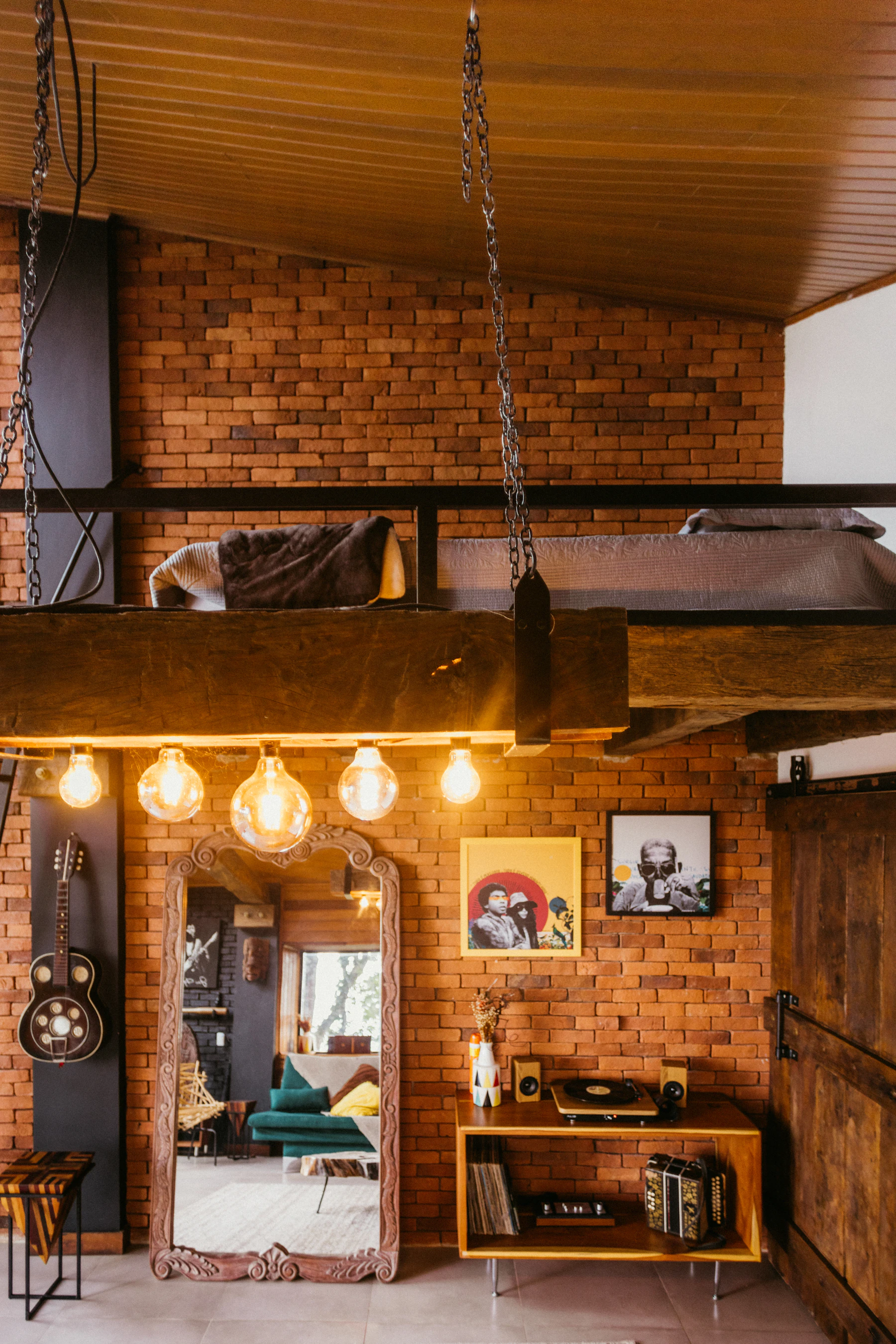 Renovated loft living room with natural light, exposed beams and warm neutral furnishings