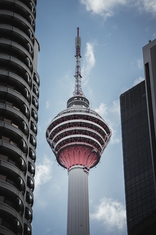A tall tower with a sky scraper in the background