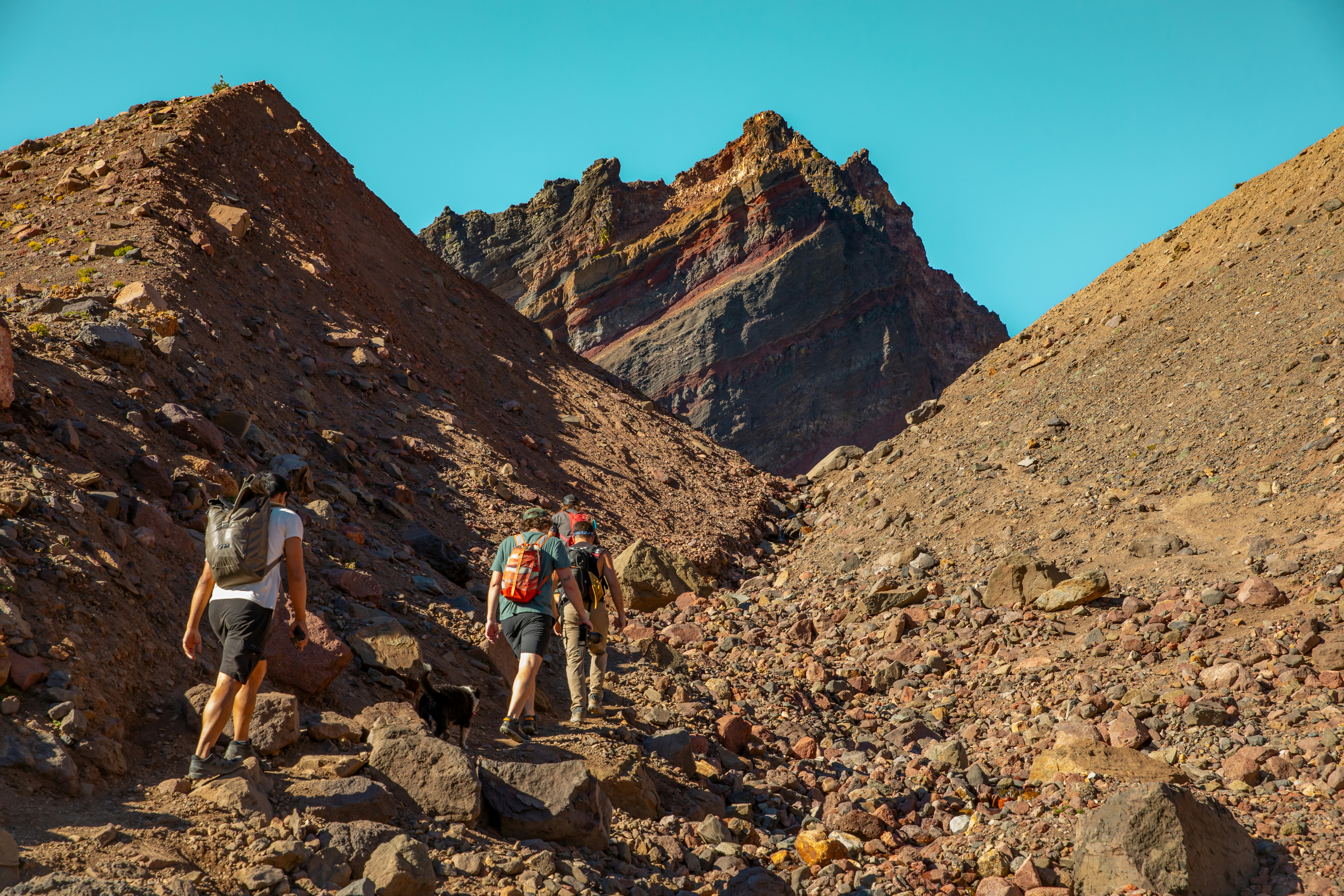 A group of people hiking up a rocky hill