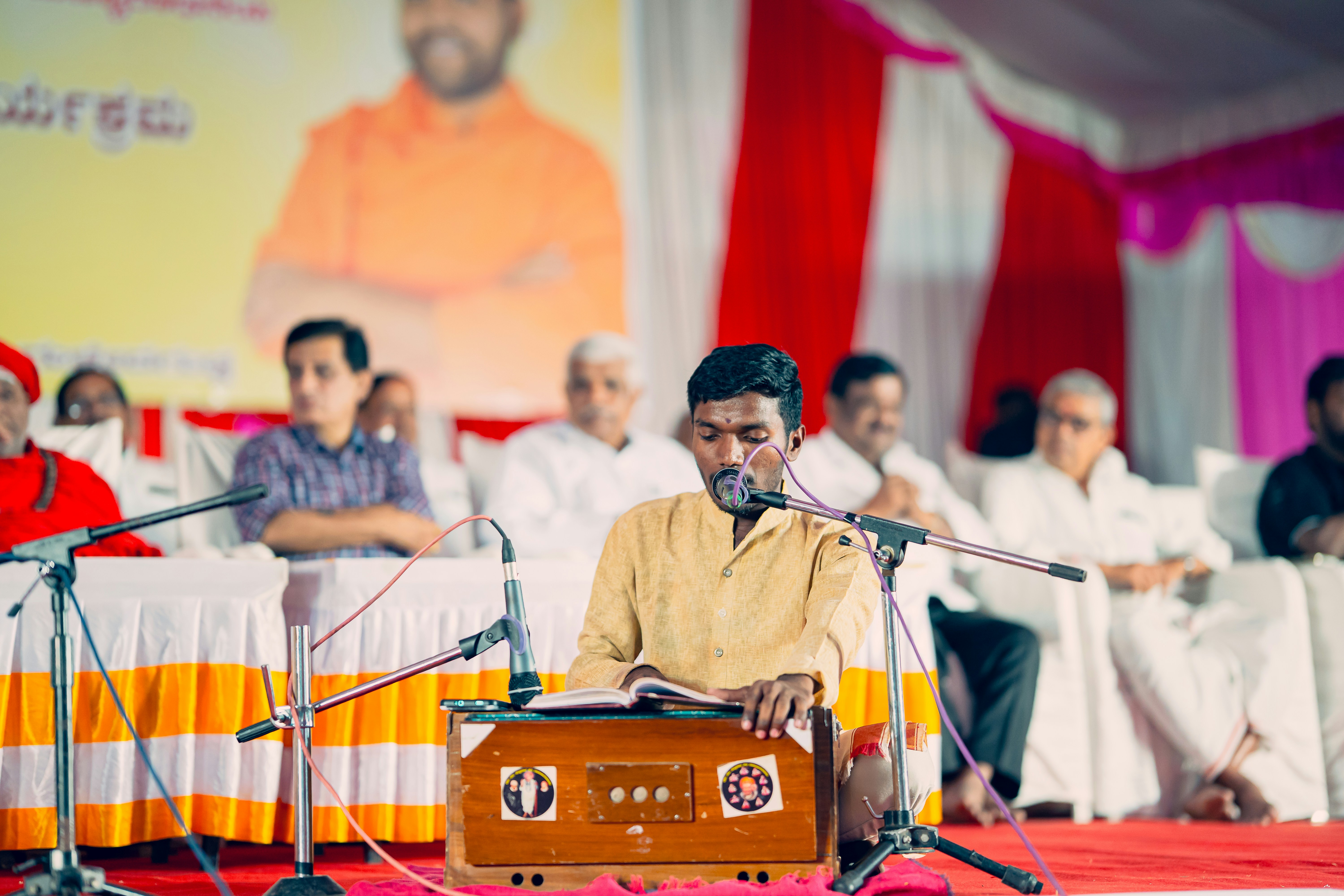 A man playing a musical instrument in front of a group of people