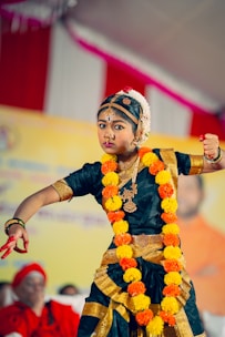 A young boy dressed in a traditional indian dance costume
