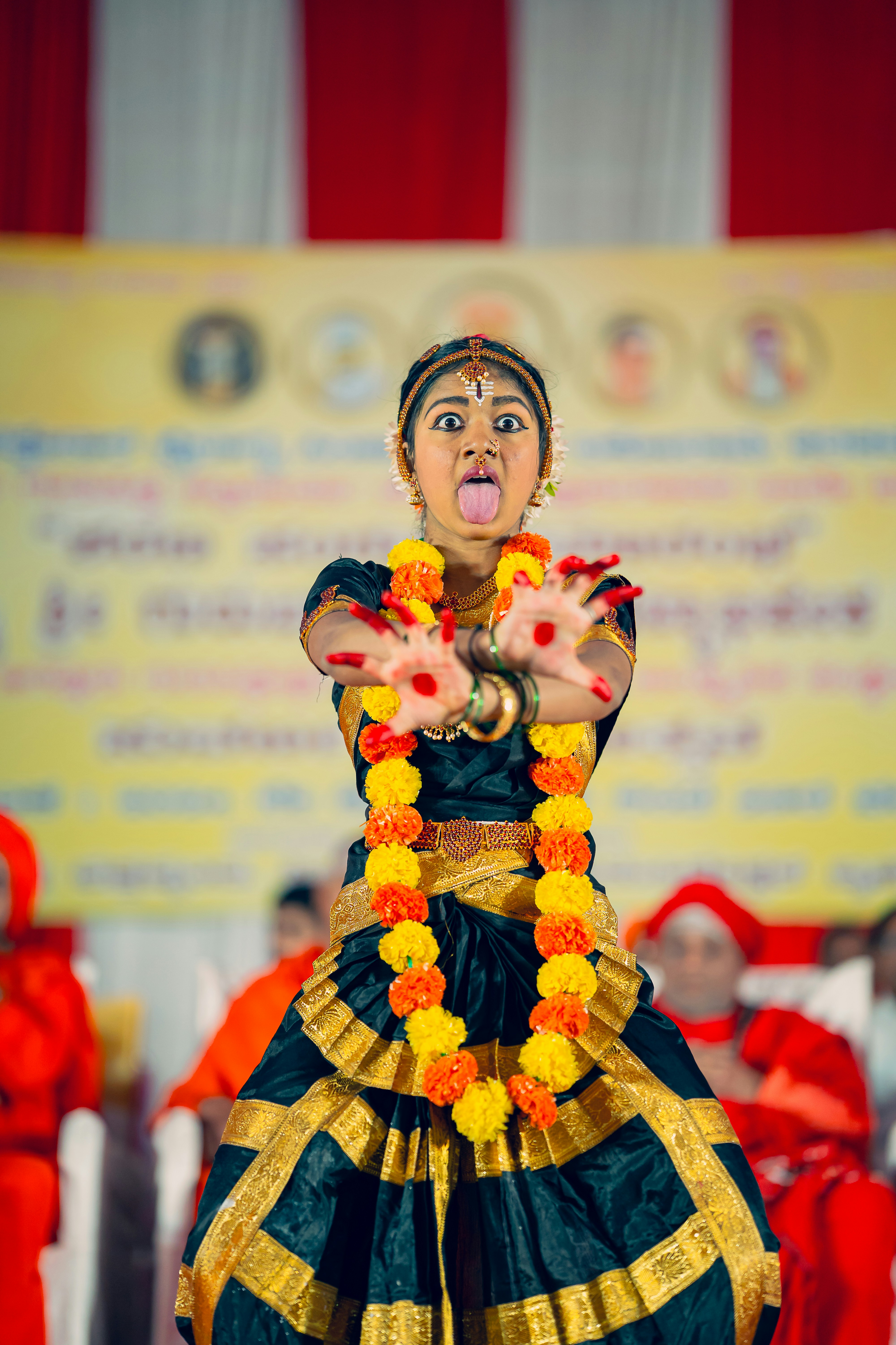A woman in a colorful dress performing a dance