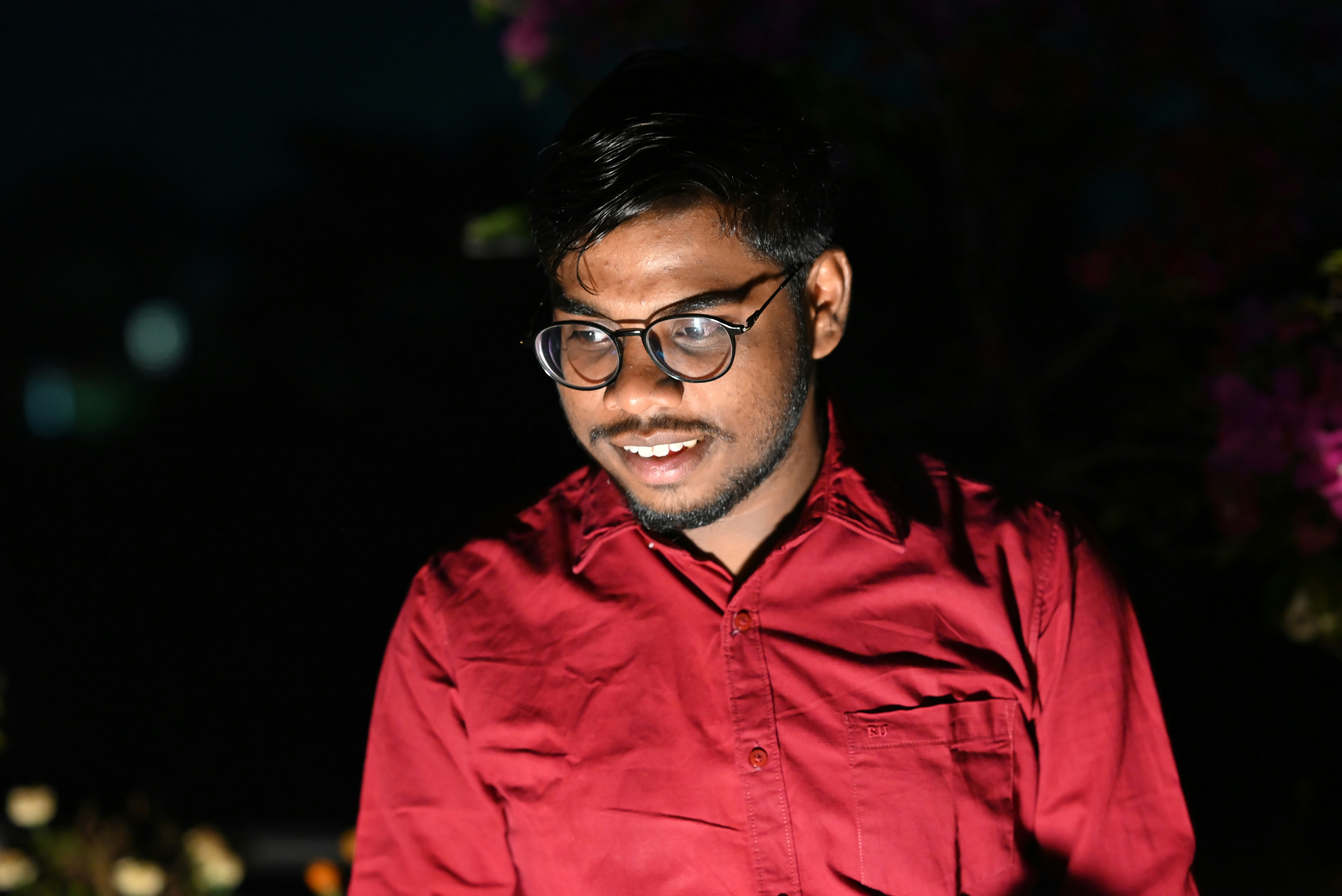 A man wearing glasses and a red shirt