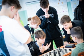 A group of young men playing a game of chess