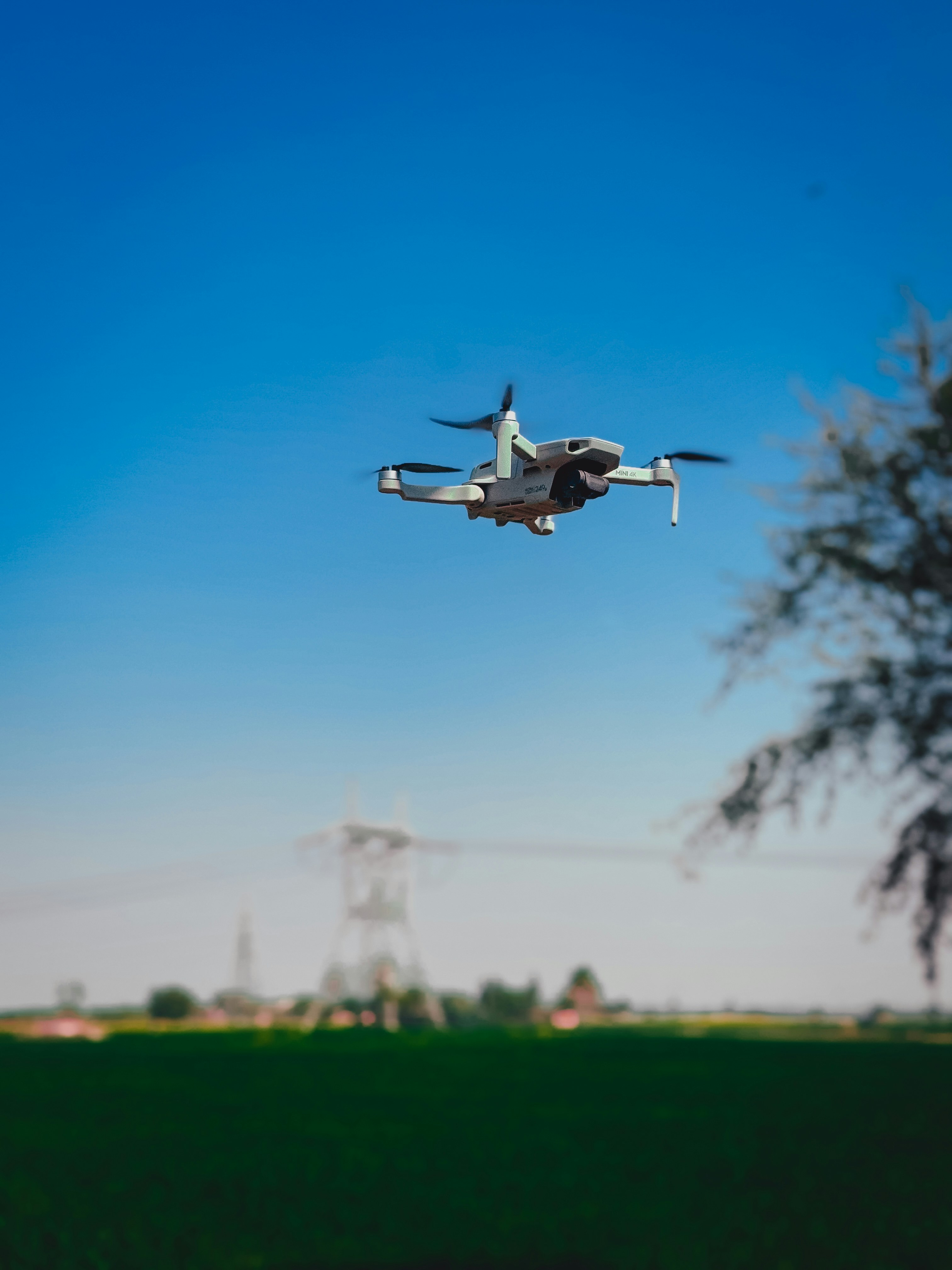 A small plane flying over a lush green field