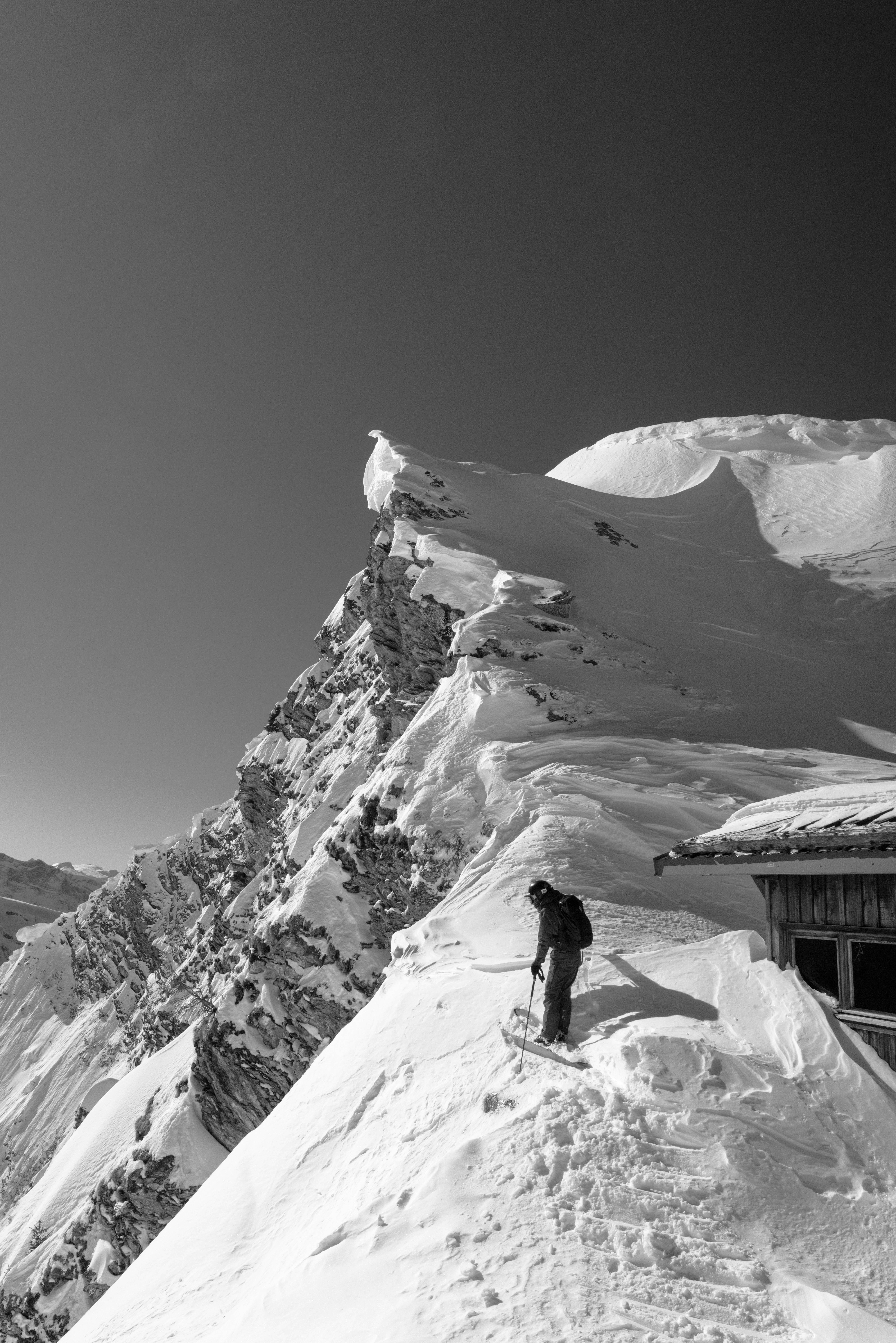 A man standing on top of a snow covered mountain