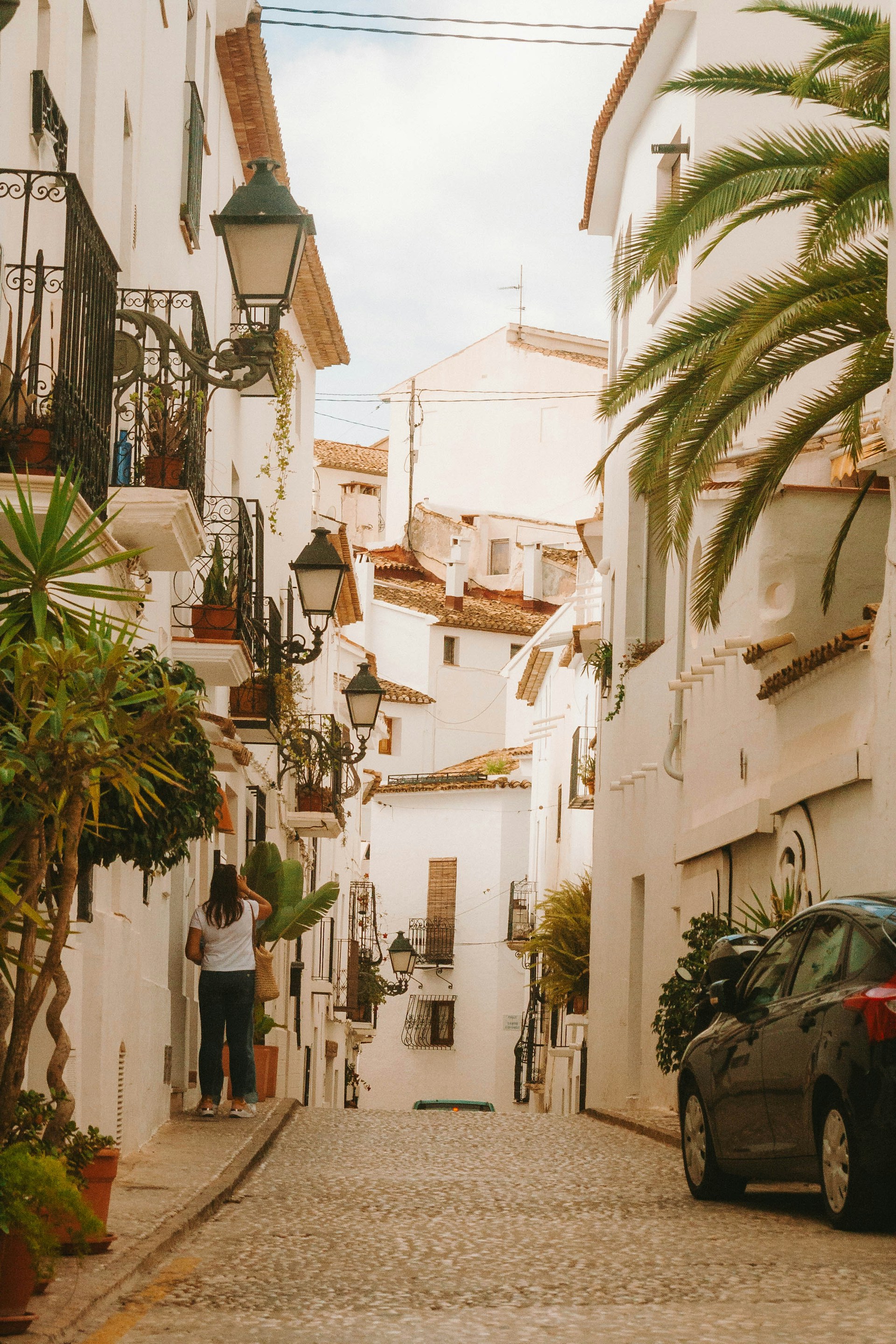 A car parked on the side of a narrow street