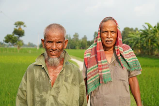 A couple of people standing next to each other in a field