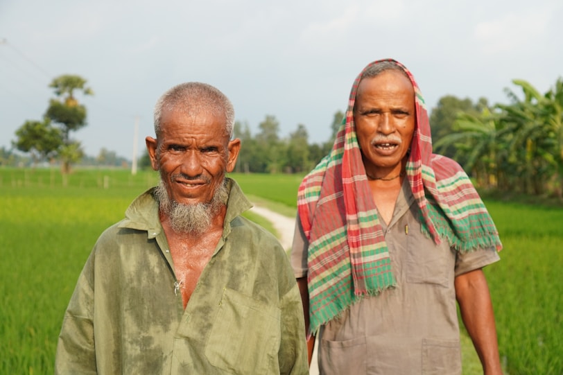 A couple of people standing next to each other in a field