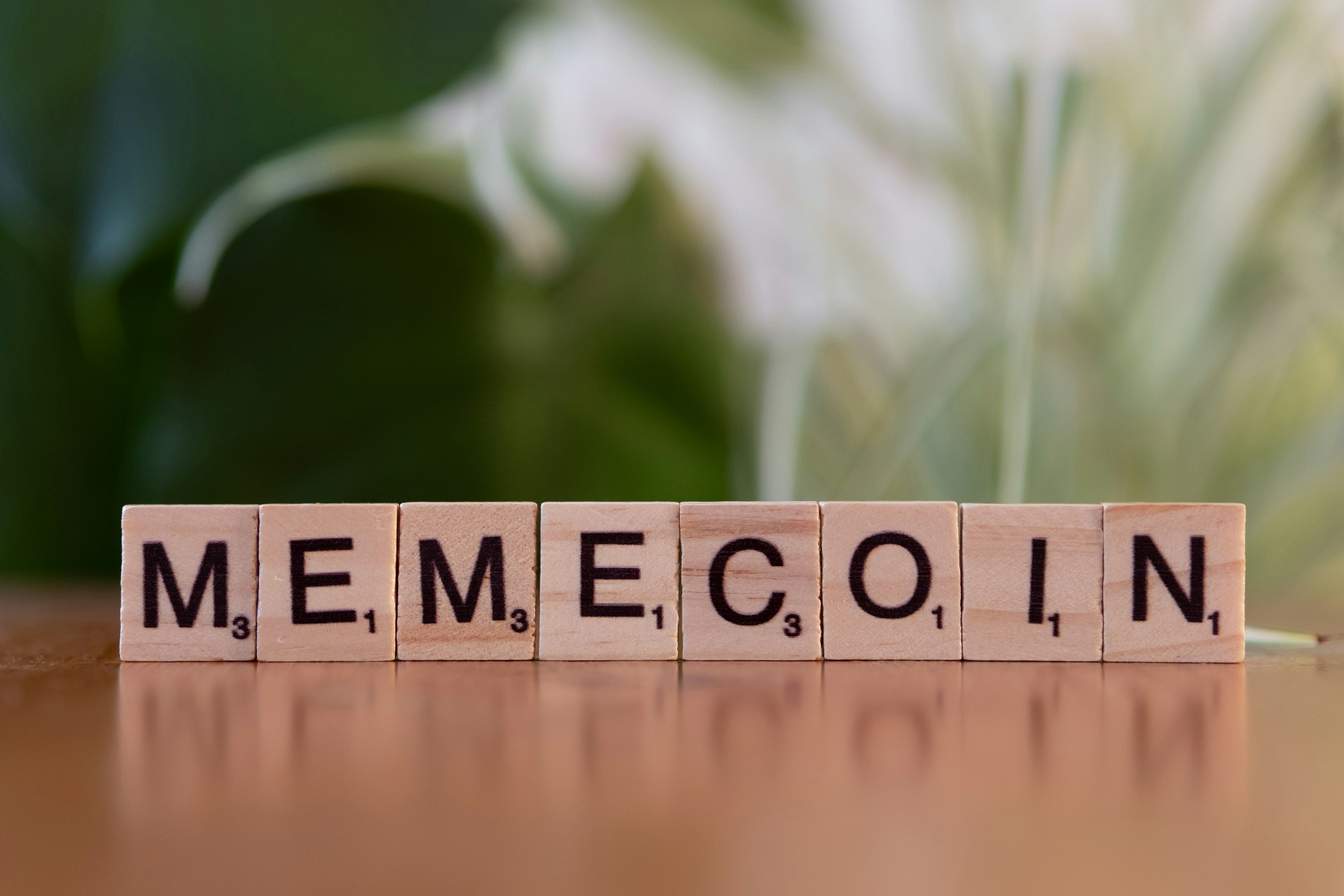 A wooden block that says memecoin on it