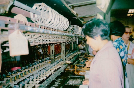 A group of people standing in front of a machine