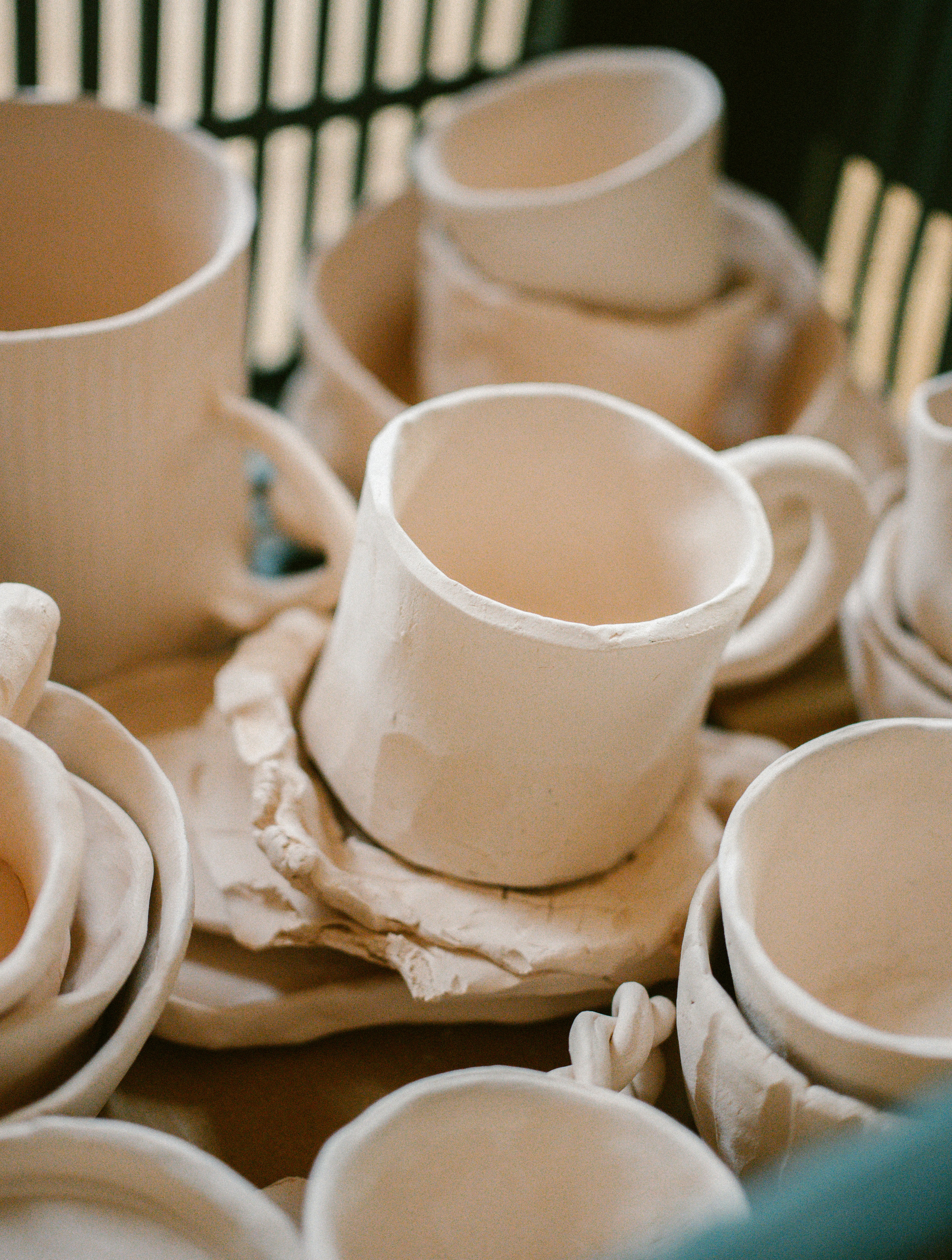 A basket filled with lots of white cups and saucers