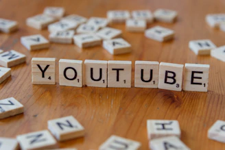 A wooden block spelling out the word youtube on a table