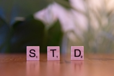 A close up of scrabble blocks spelling the word std