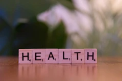 A wooden block spelling the word health on a table