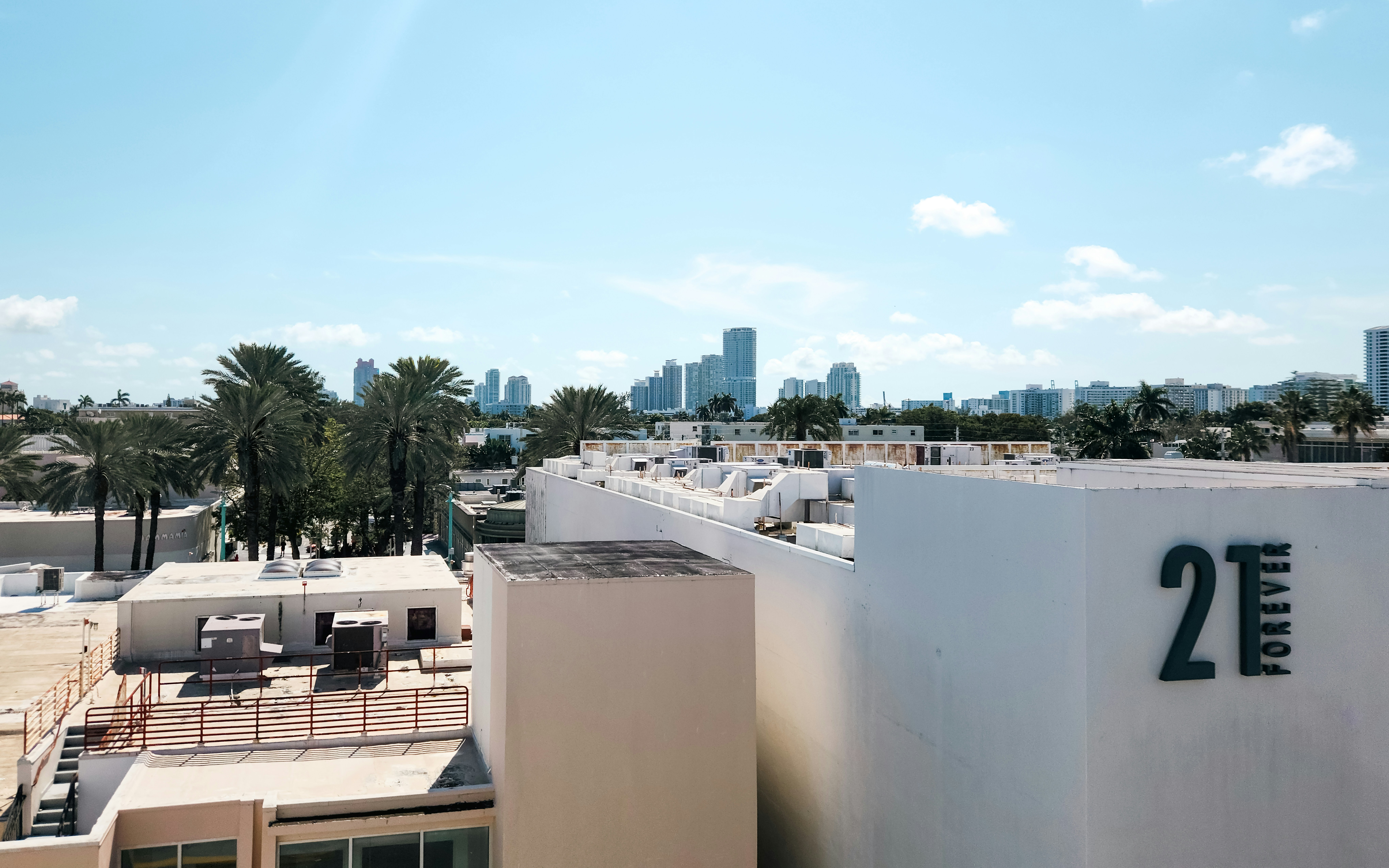 Miami high-rise amenities featuring a rooftop pool deck with city views