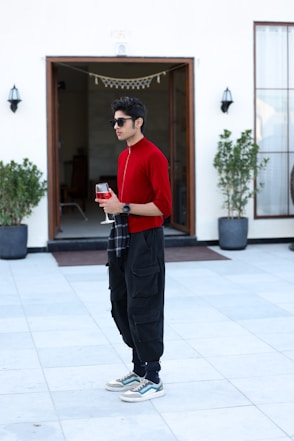 A man in a red shirt and black pants