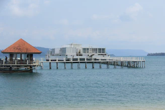 A pier with a small hut on top of it