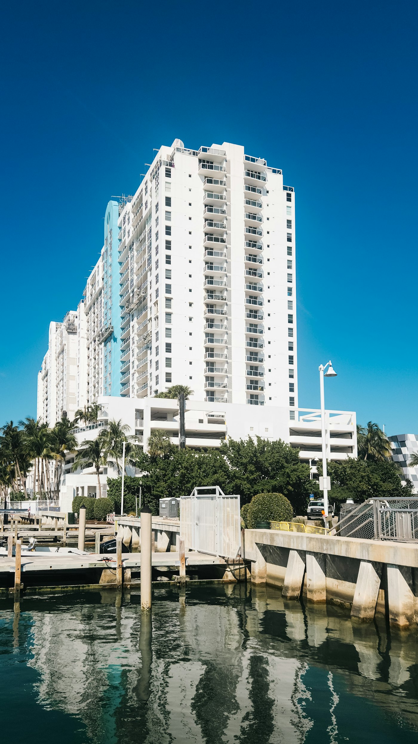 Modern white condo tower next to the water