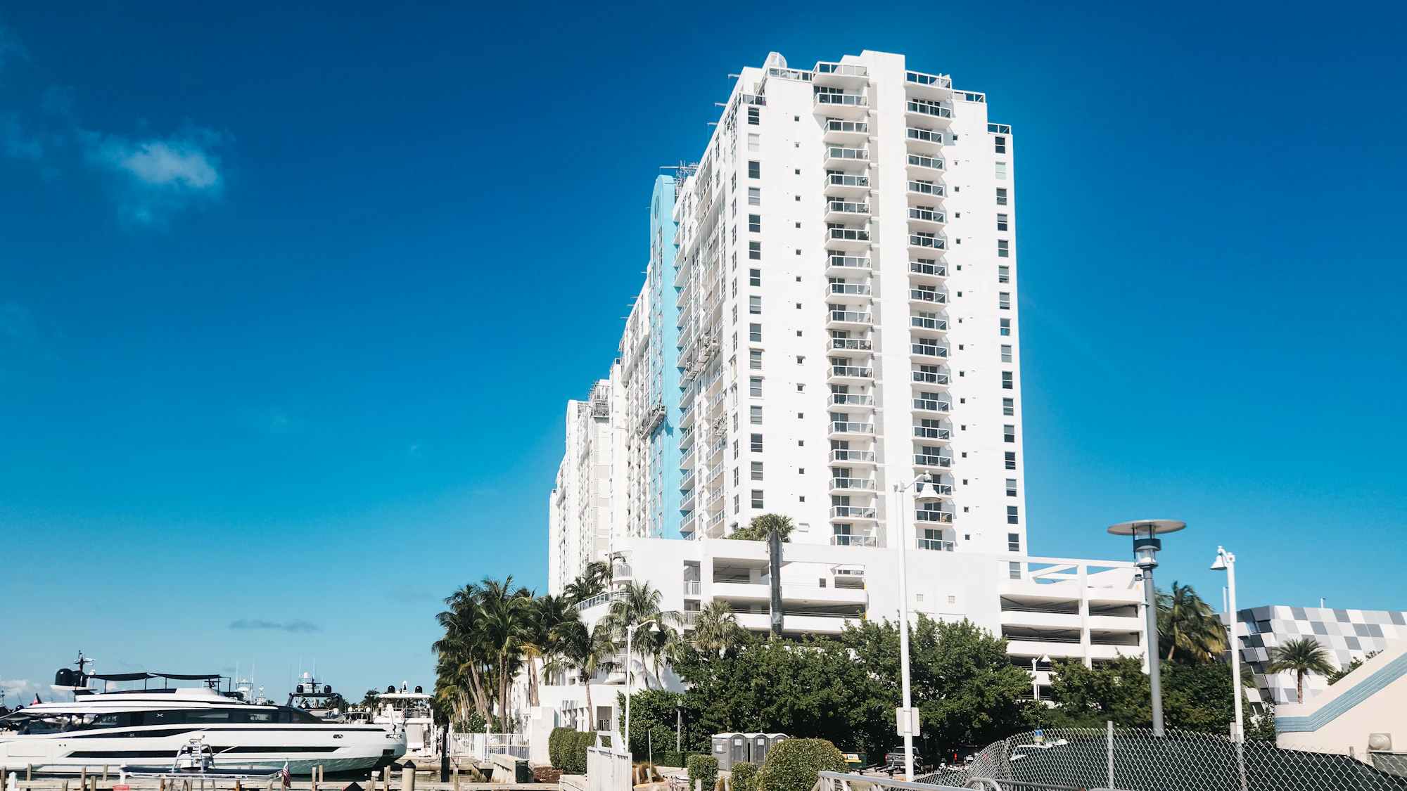 White condominium tower against a blue sky