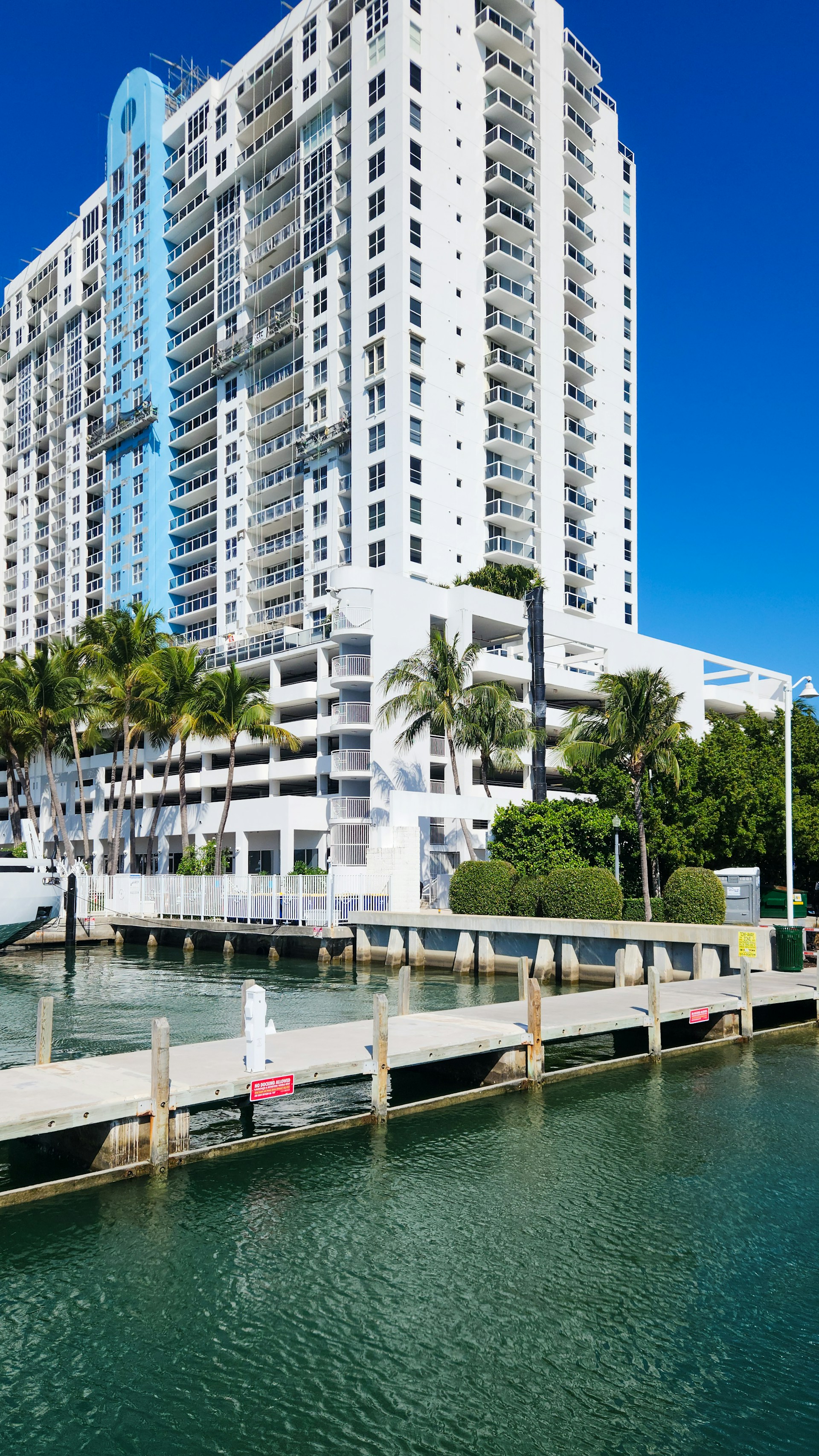 A large white building sitting next to a body of water