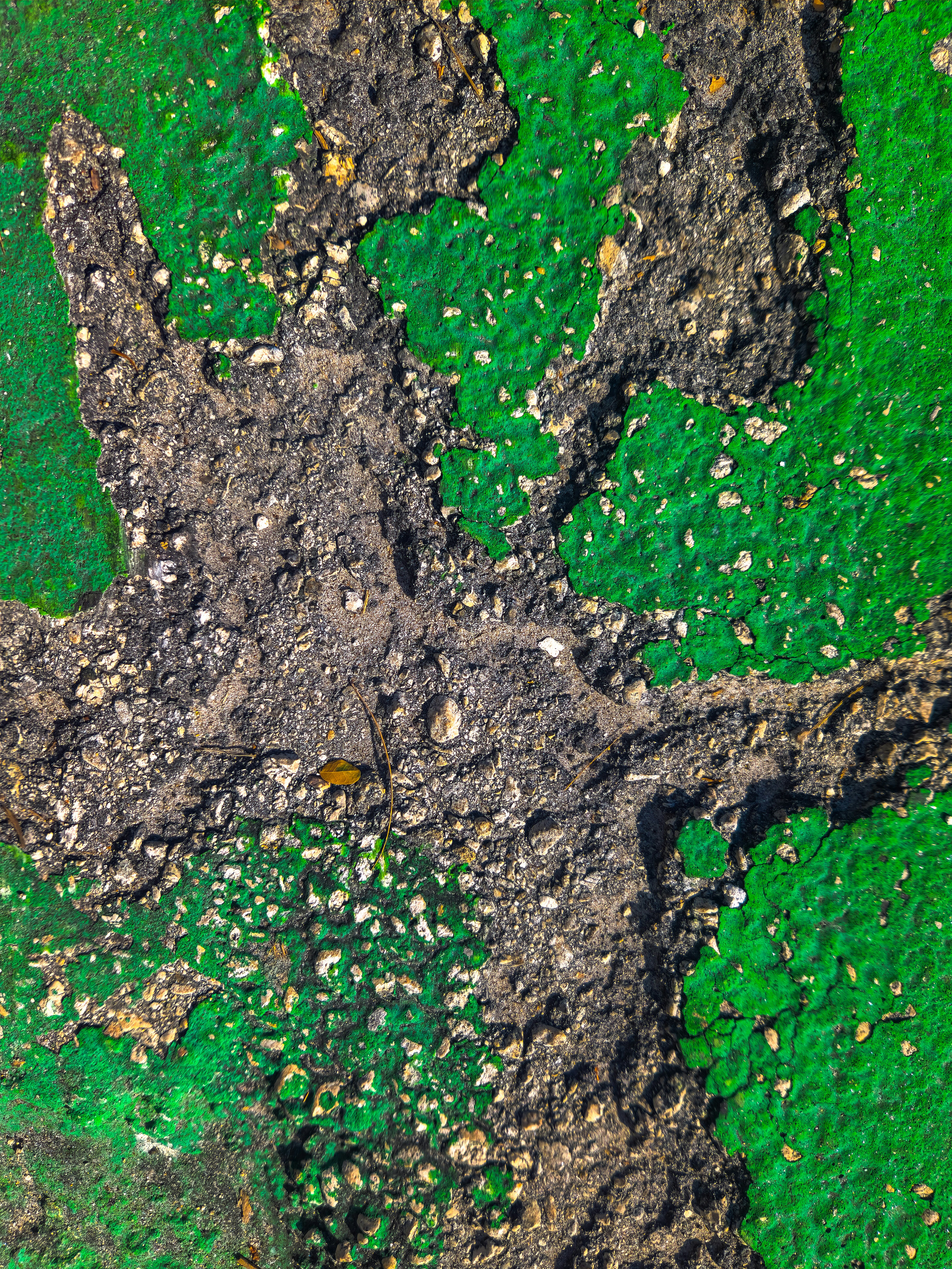 A close up of a cross on a green surface