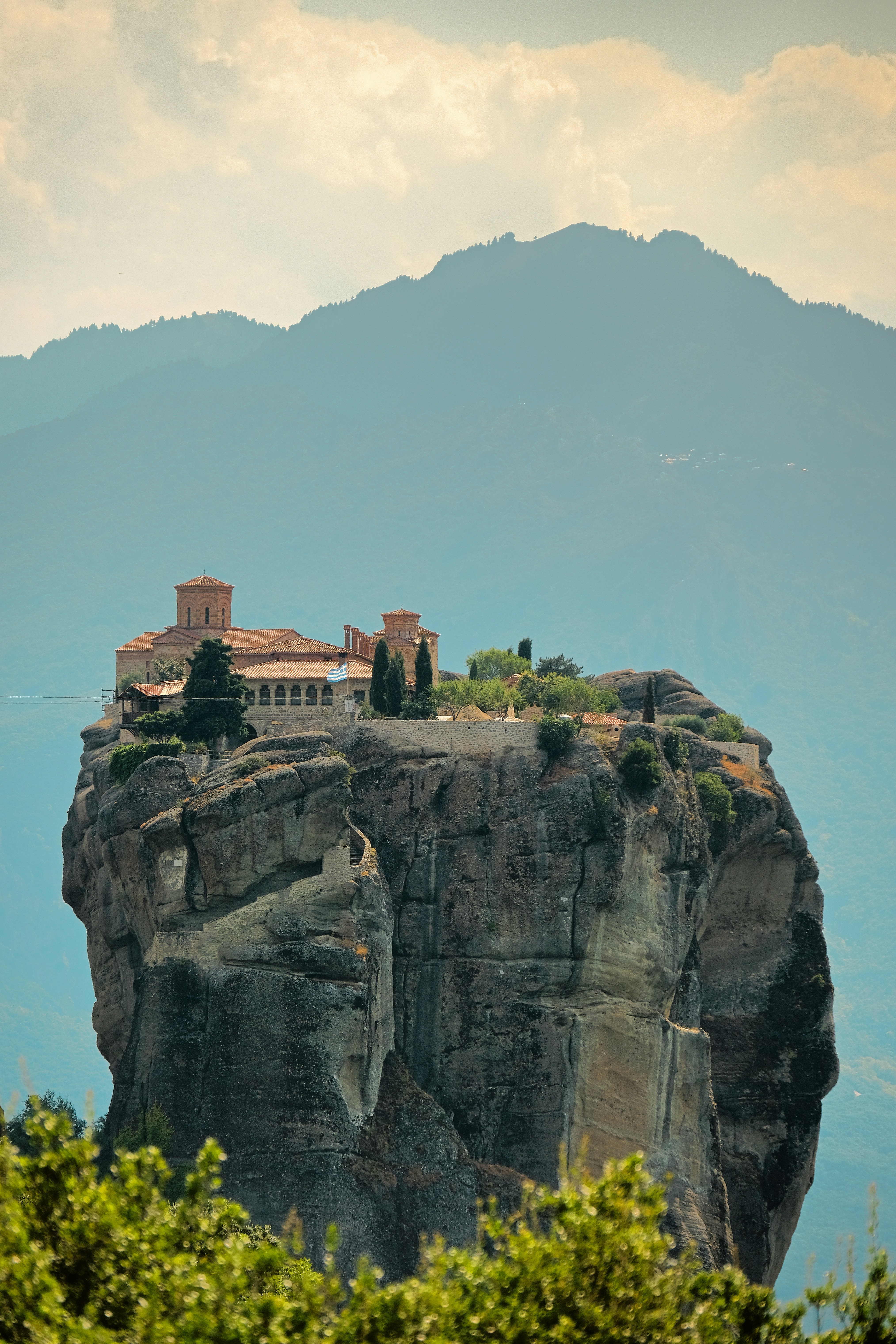A large rock with a house on top of it